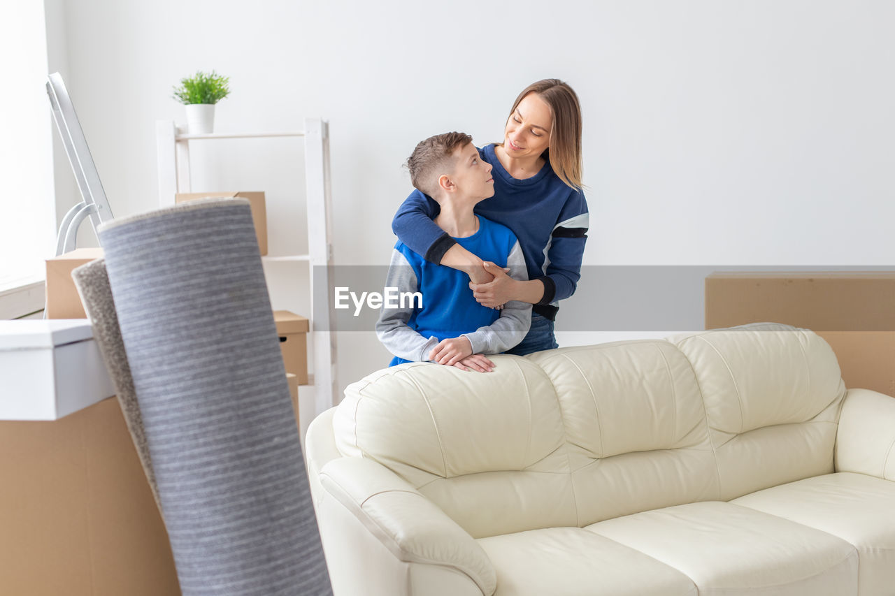 WOMAN SITTING ON SOFA