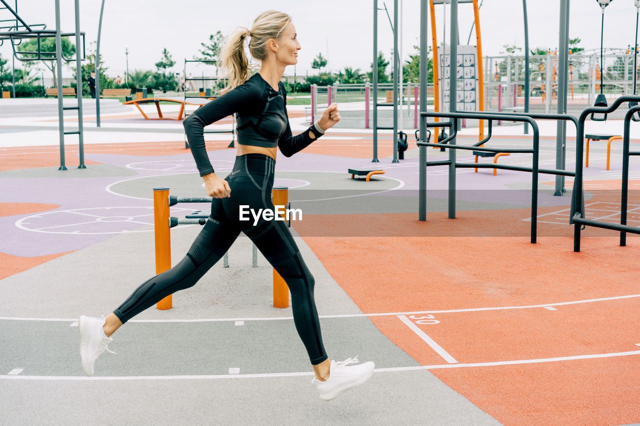 Woman athlete runner trains on the sports ground. person