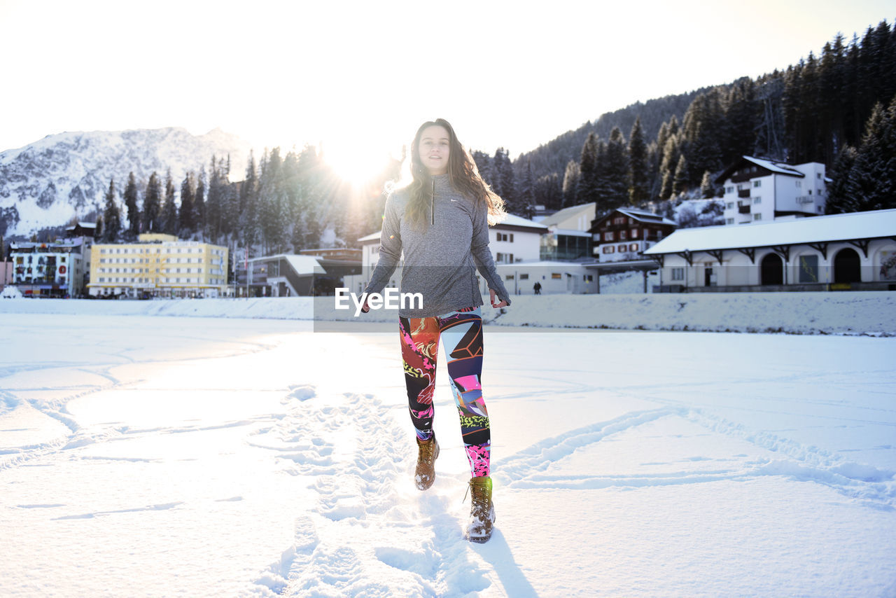 Full length of woman walking on snow covered land