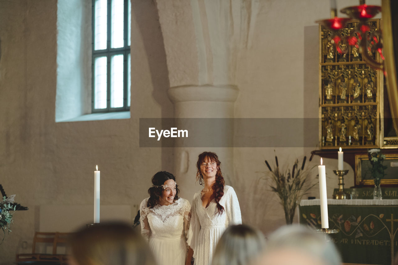 Brides at wedding ceremony