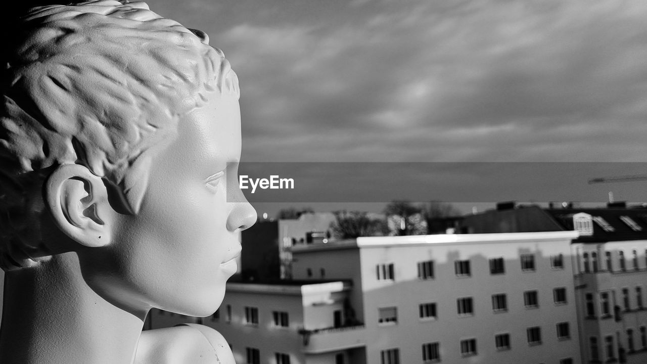 black and white, white, architecture, monochrome, monochrome photography, sky, black, childhood, building exterior, built structure, child, statue, cloud, sculpture, representation, nature, city, building, human representation, outdoors, headshot, creativity, day, side view, one person