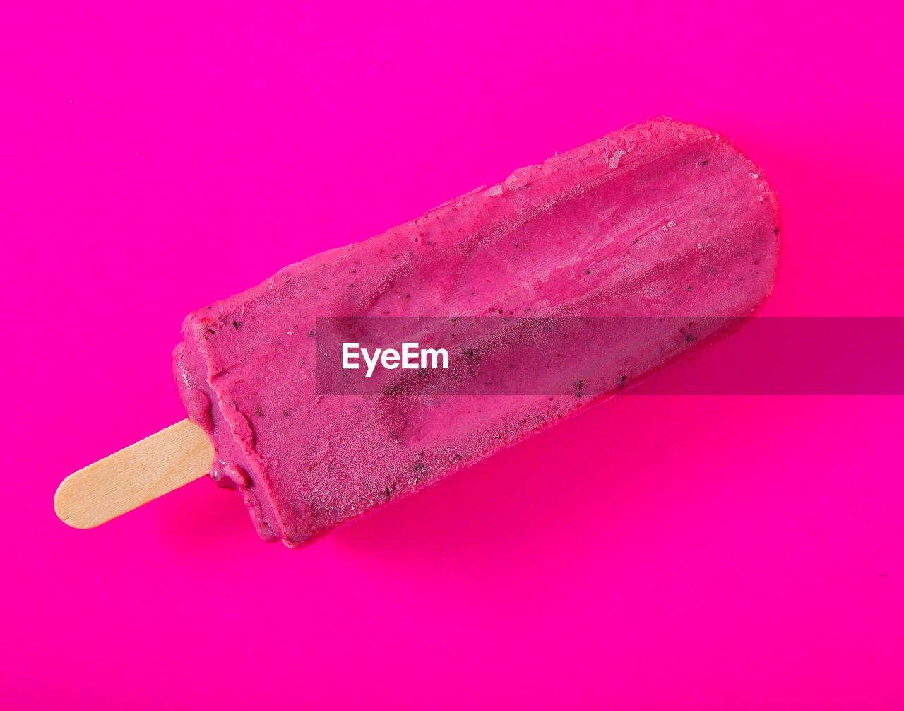 Close-up of ice cream over pink background