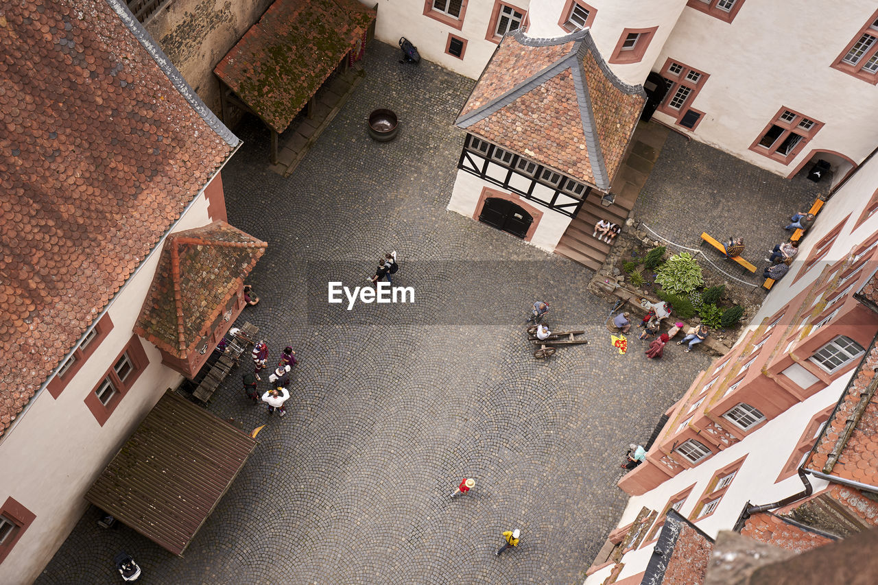 HIGH ANGLE VIEW OF PEOPLE ON STREET BY BUILDINGS