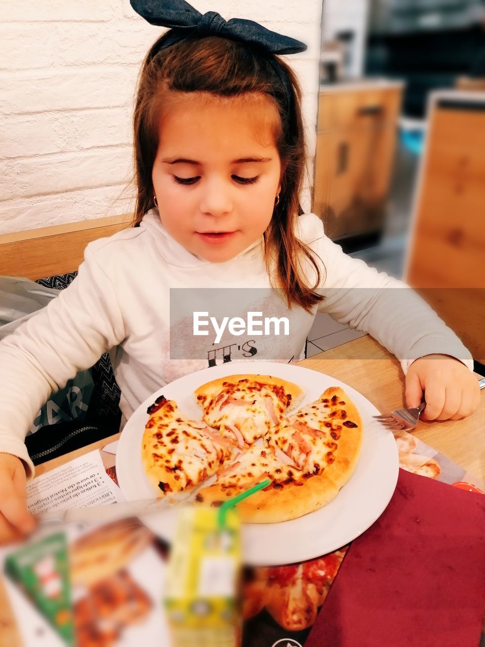 Close-up of girl with ice cream on table