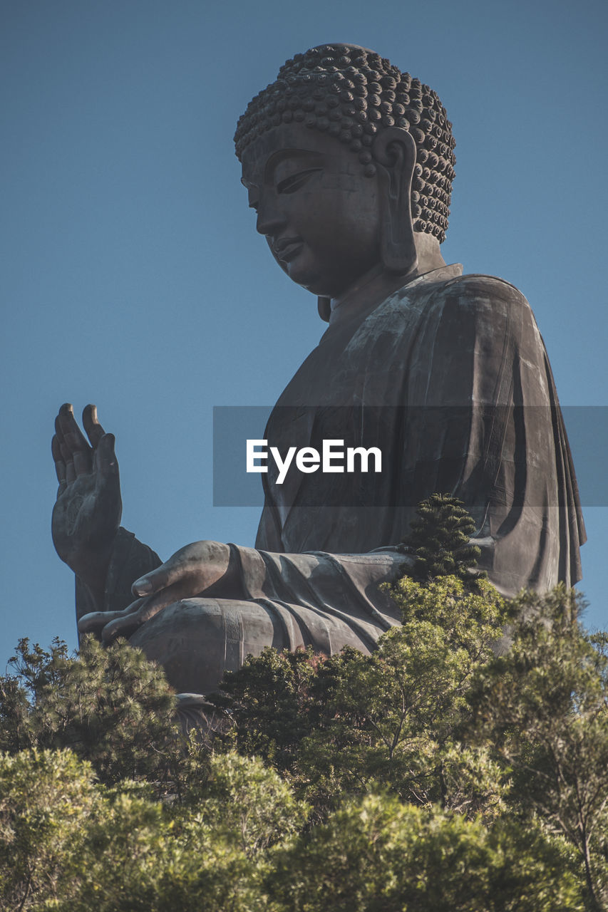 Low angle view of statue against sky