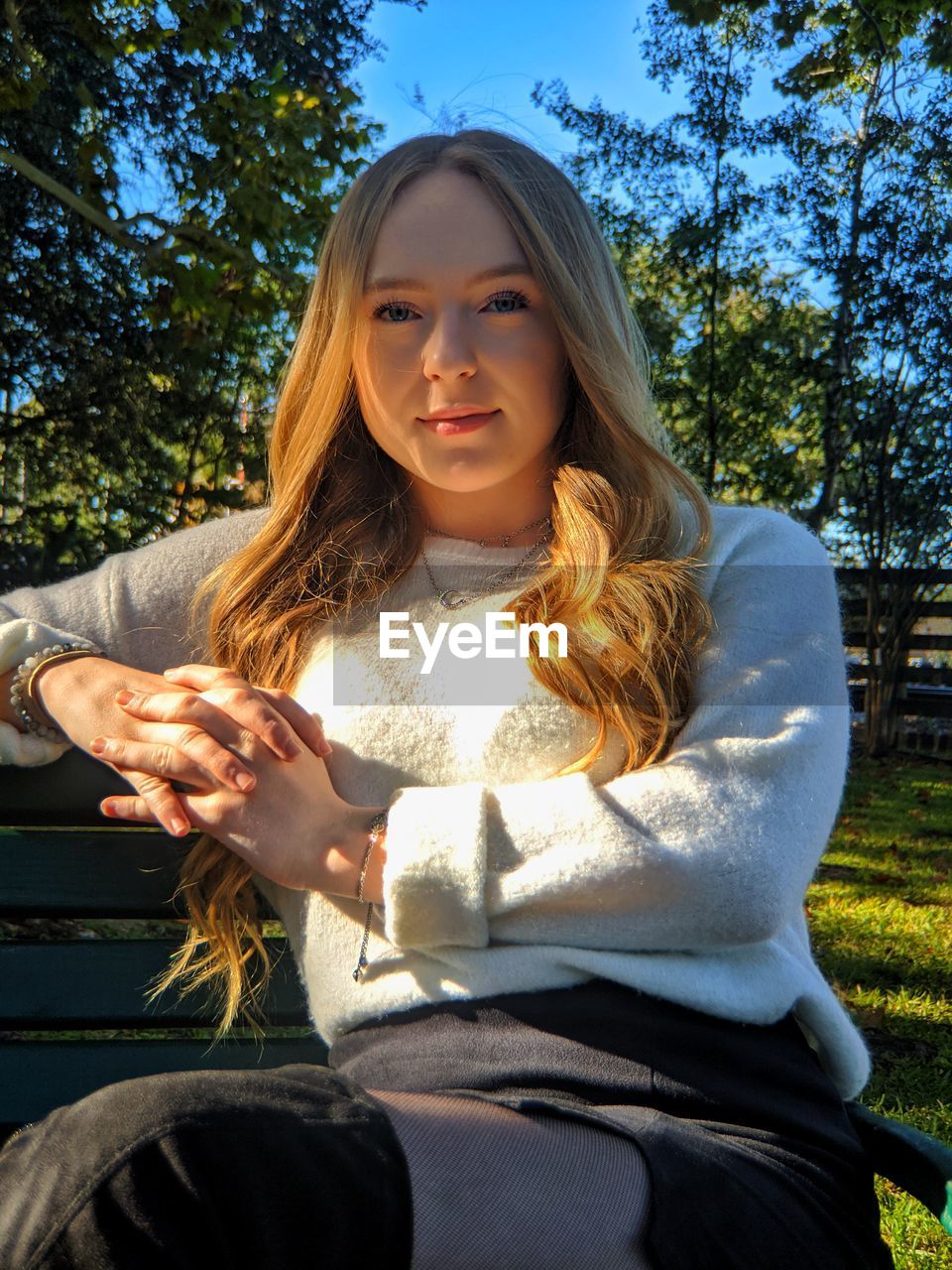 Portrait of young woman sitting outdoors