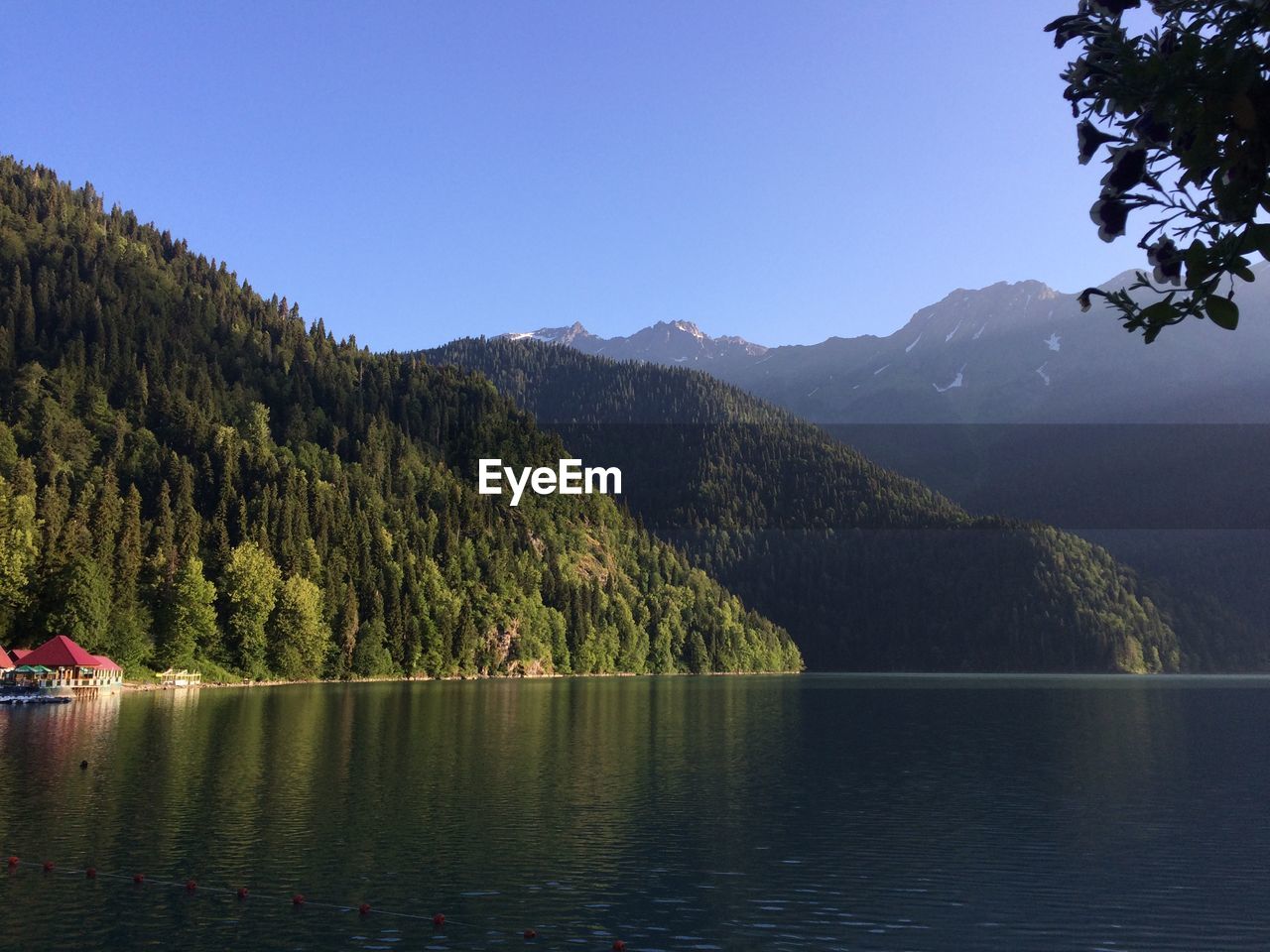 Scenic view of lake and mountains against clear sky