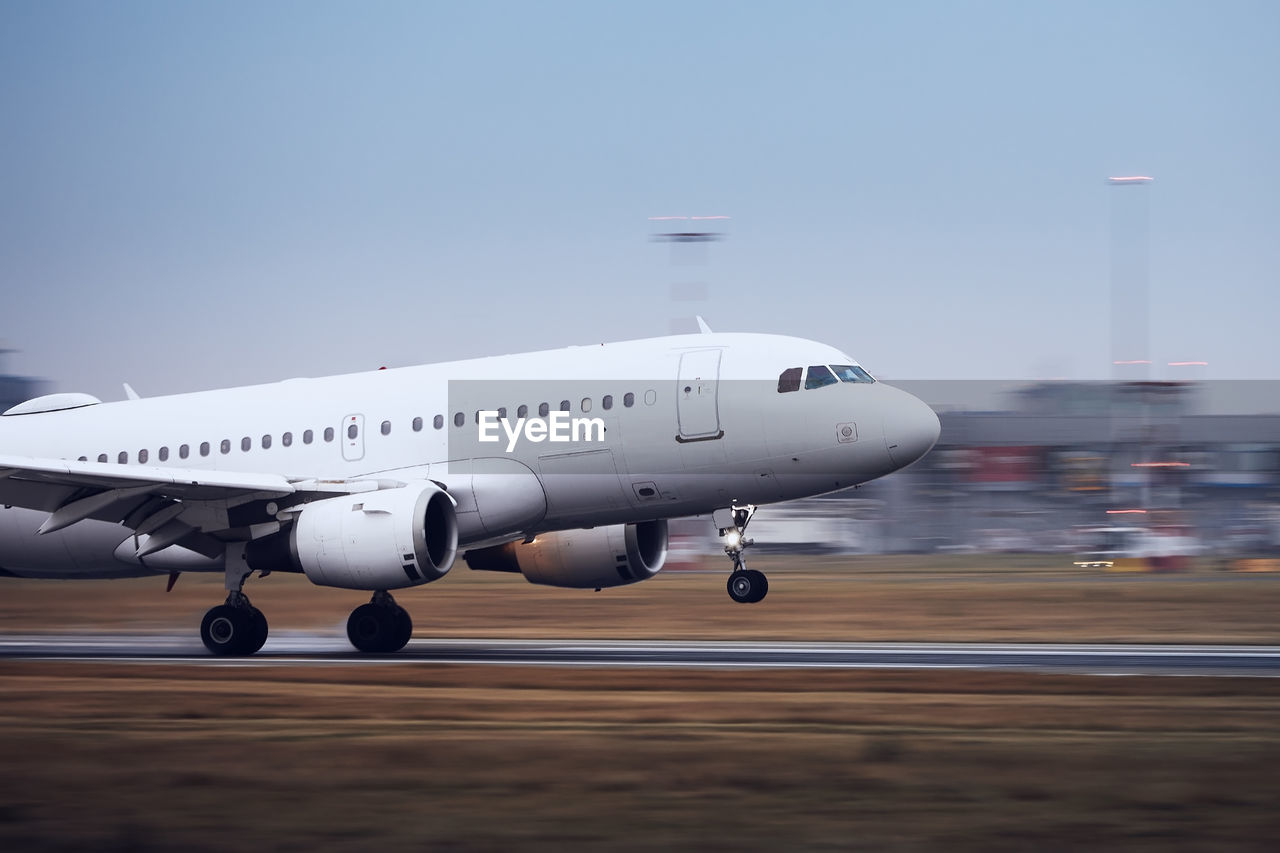 Airplane during landing on airport runway at night. plane in blurred motion.