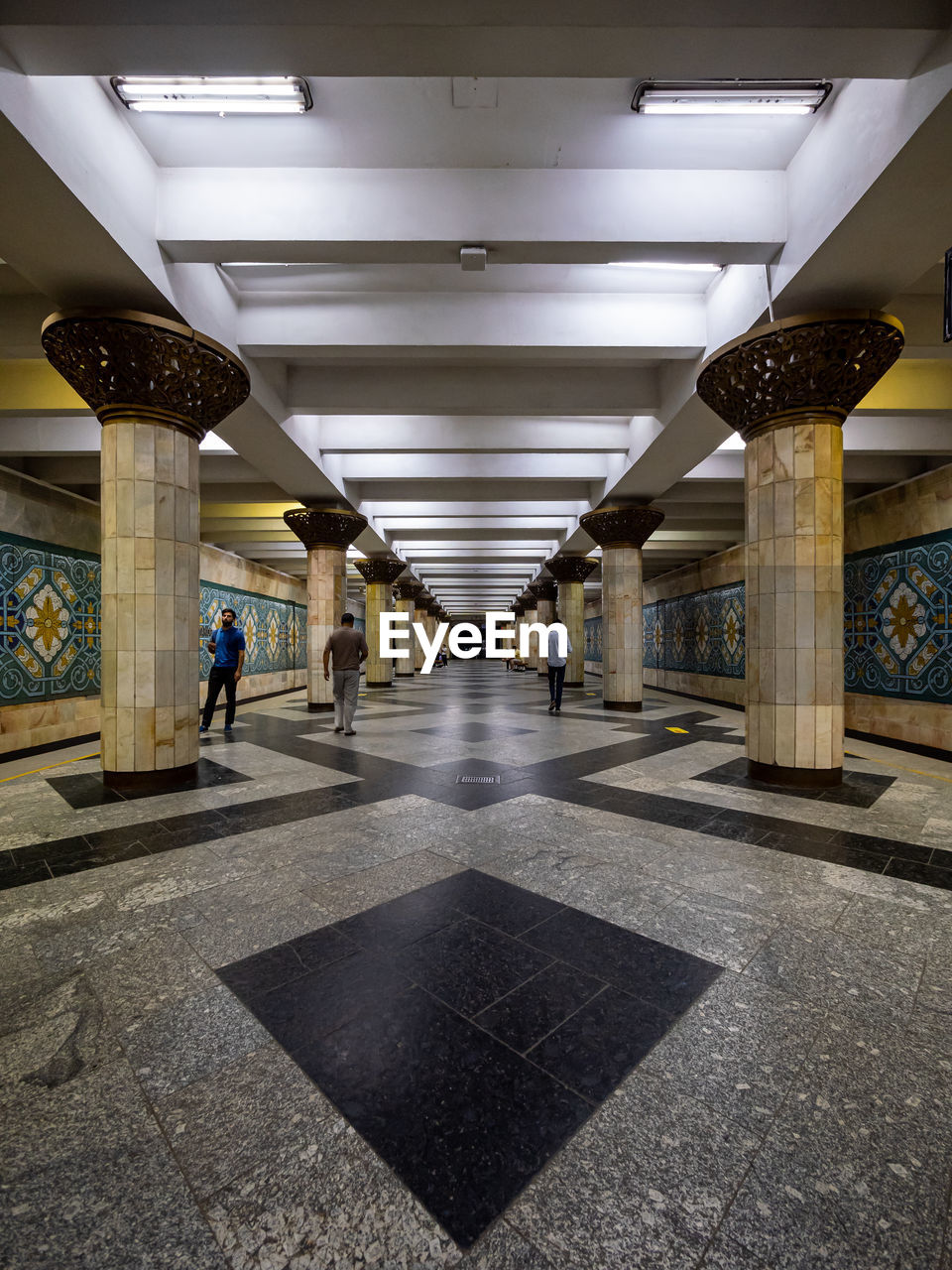 architecture, built structure, indoors, transportation, illuminated, city, building, architectural column, lighting equipment, ceiling, interior design, lobby, arcade, travel, corridor, flooring, subway