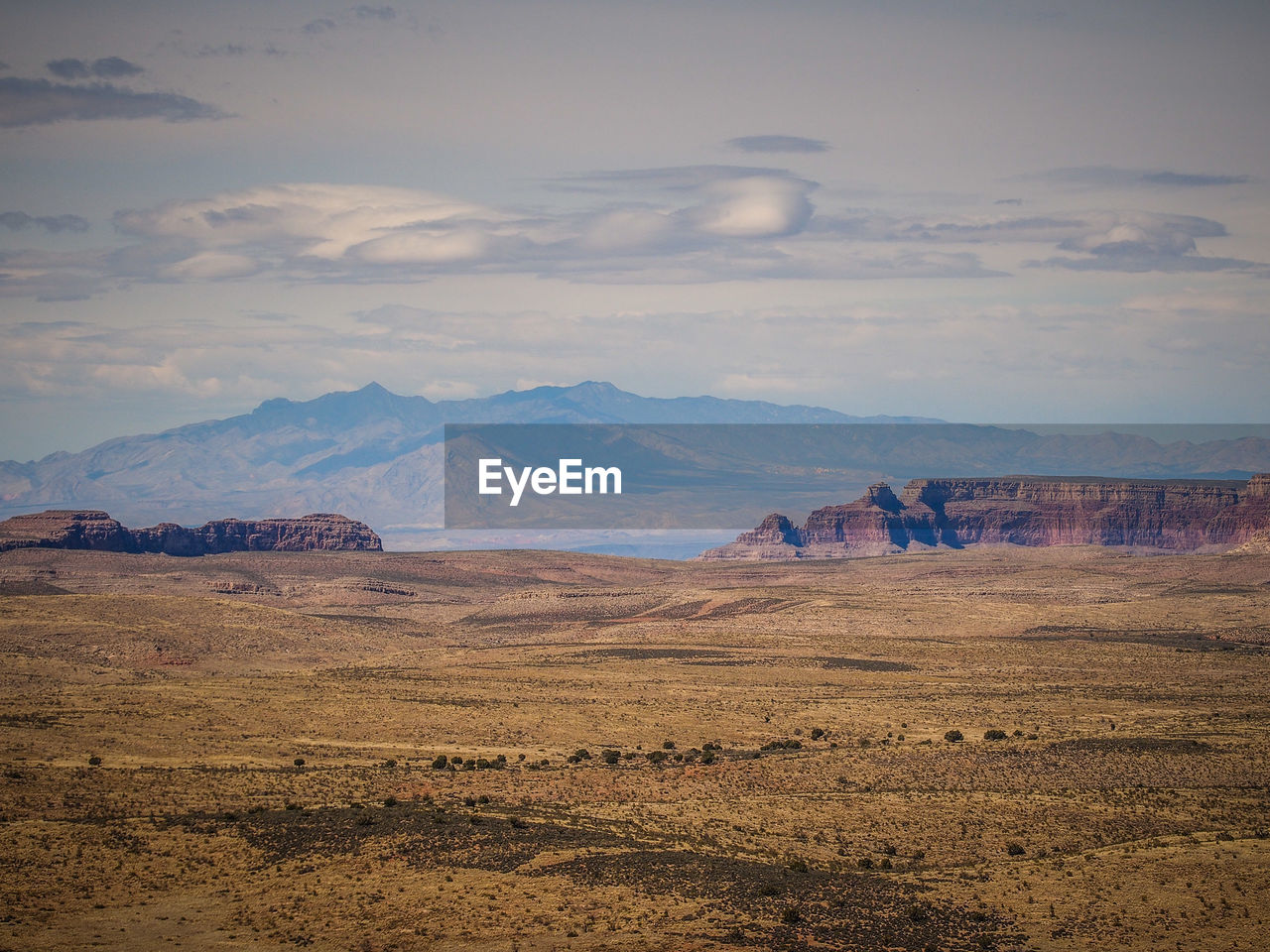 SCENIC VIEW OF MOUNTAINS AGAINST CLOUDY SKY