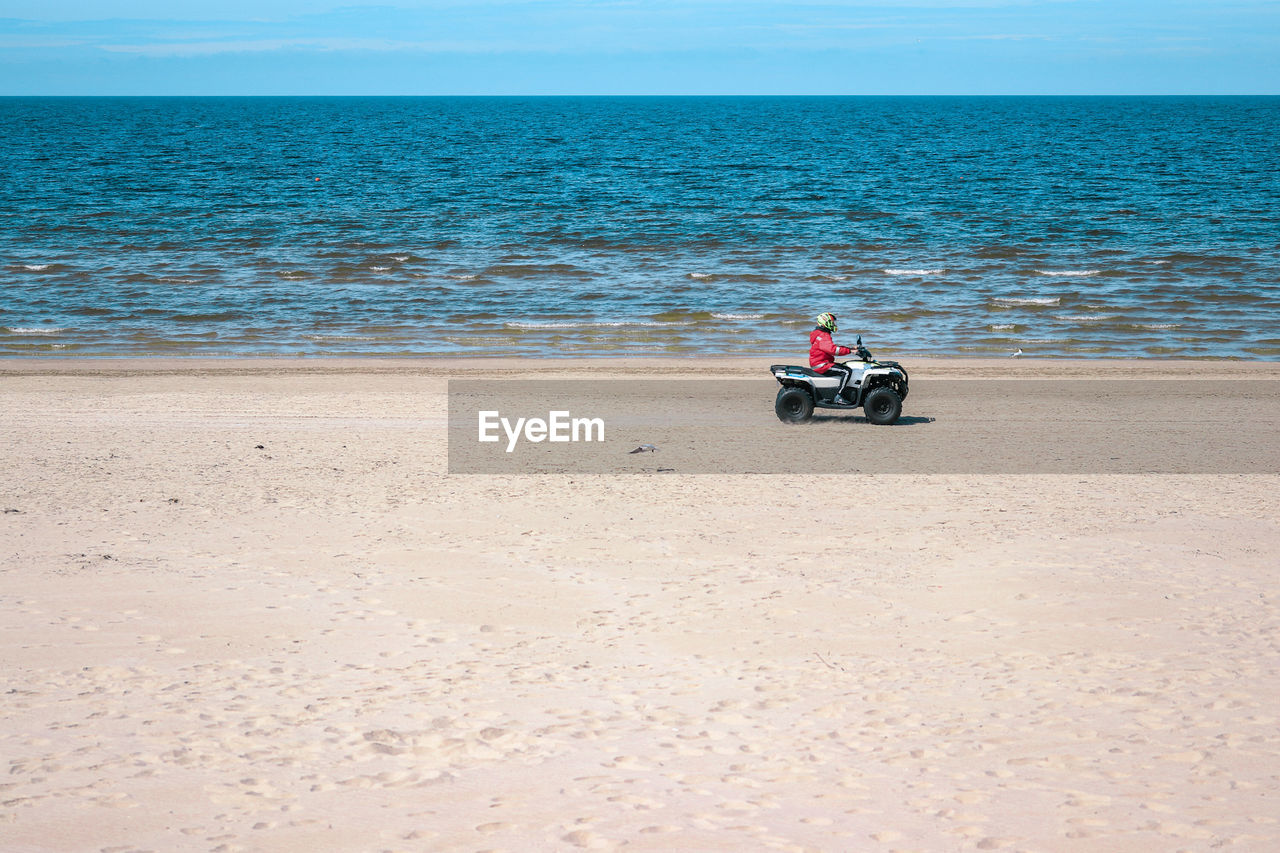 Man riding motorcycle on beach