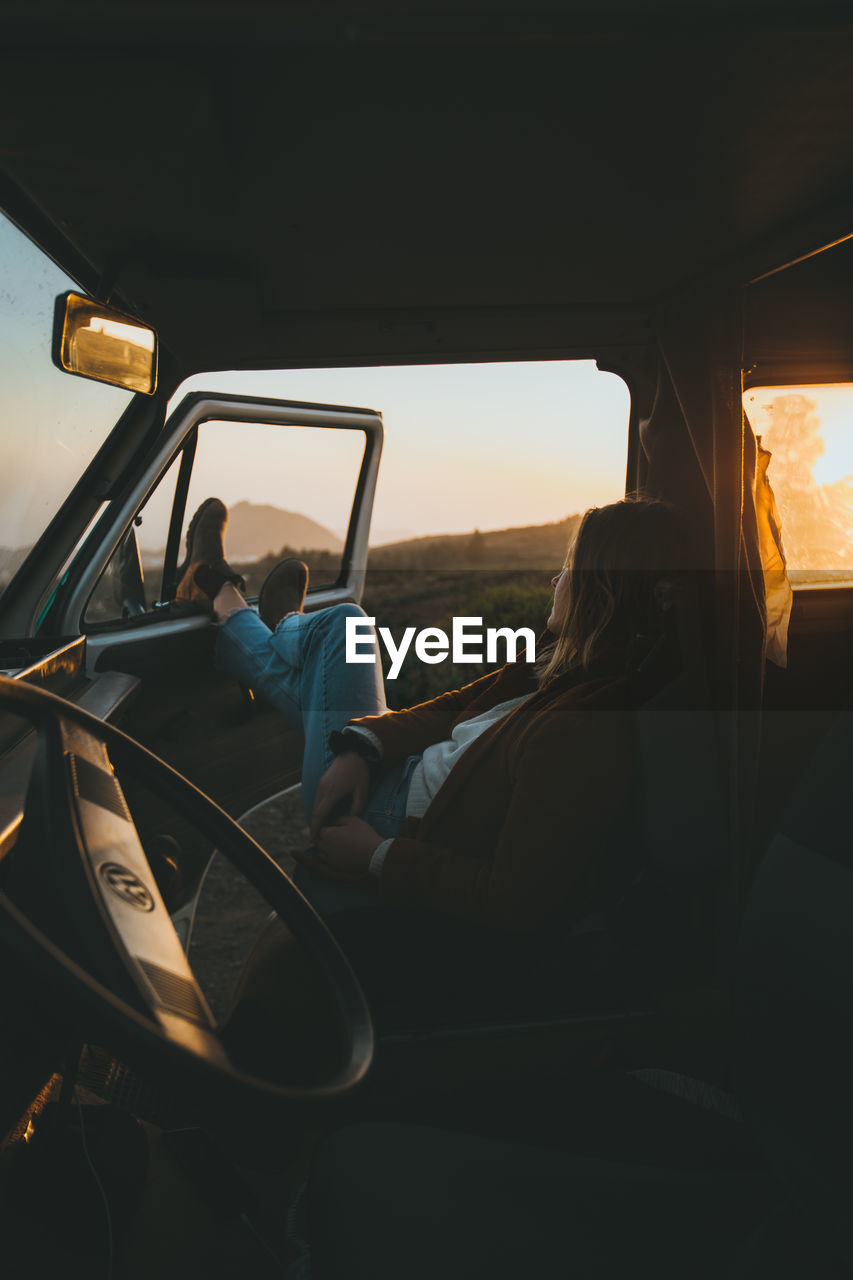 MAN SITTING IN CAR SEEN THROUGH WINDOW