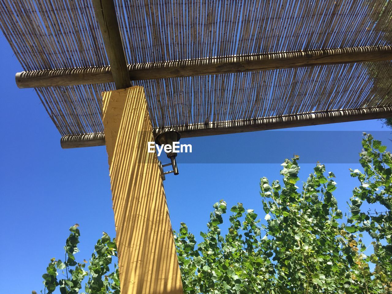 LOW ANGLE VIEW OF METALLIC STRUCTURE AGAINST BLUE SKY