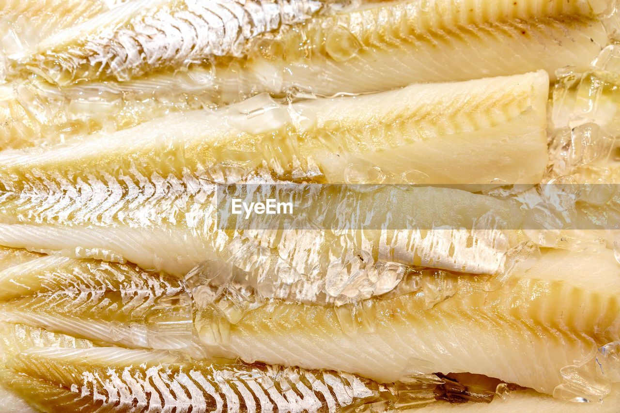 Full frame shot of dead fishes with ice for sale at market
