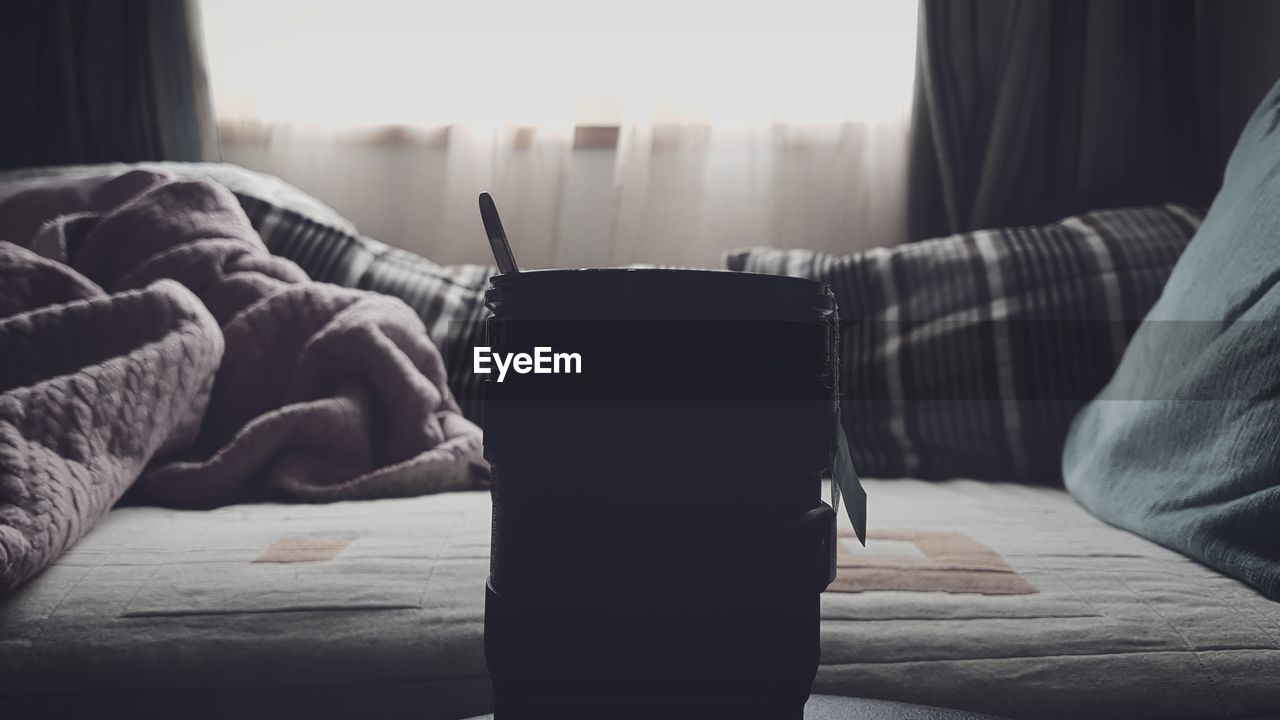 CLOSE-UP OF MAN RELAXING ON BED AT HOME