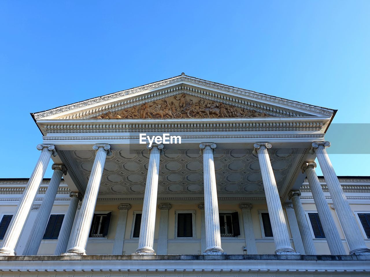 Low angle view of historical building against clear blue sky