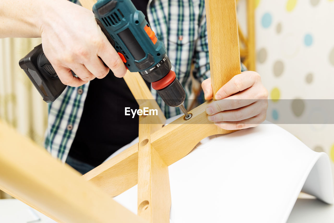 cropped hand of man working on table