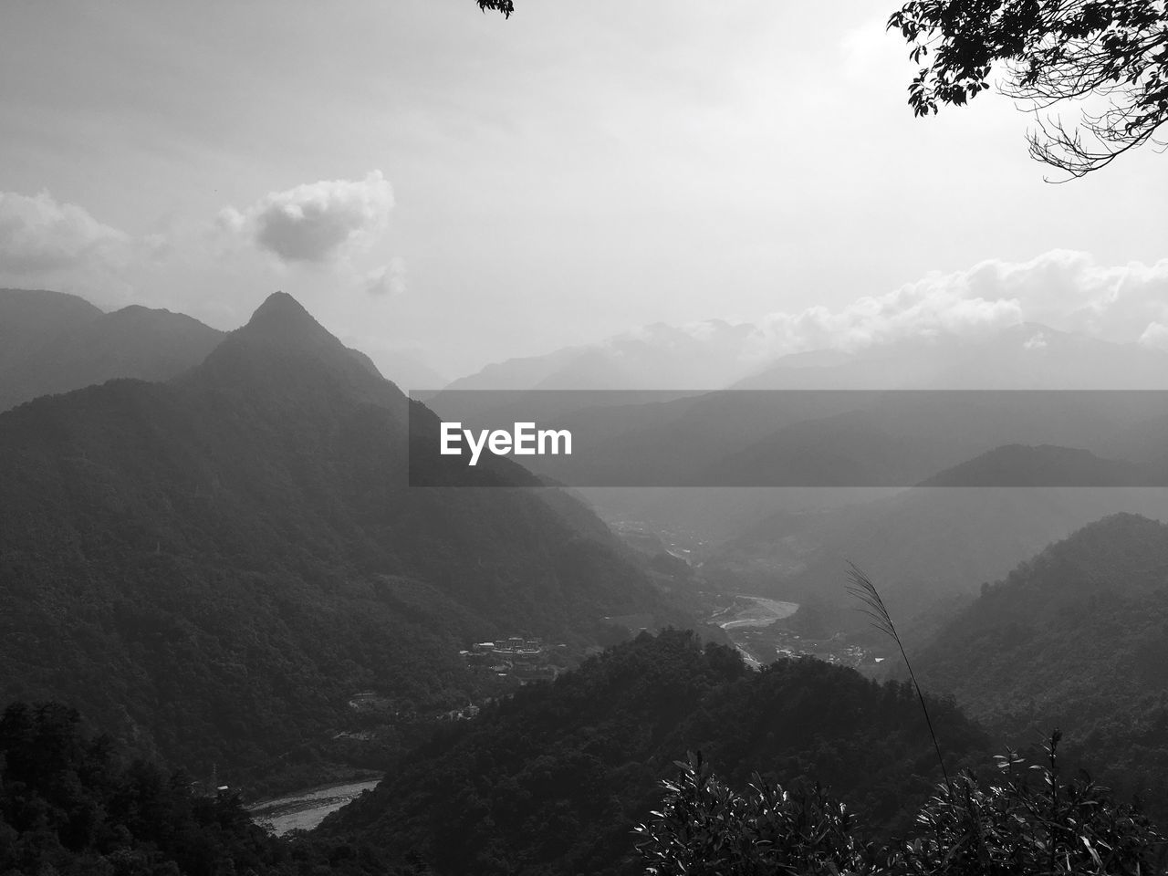 SCENIC VIEW OF TREES AND MOUNTAINS AGAINST SKY