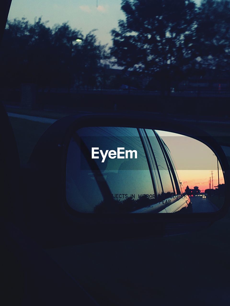 Car reflecting in side-view mirror