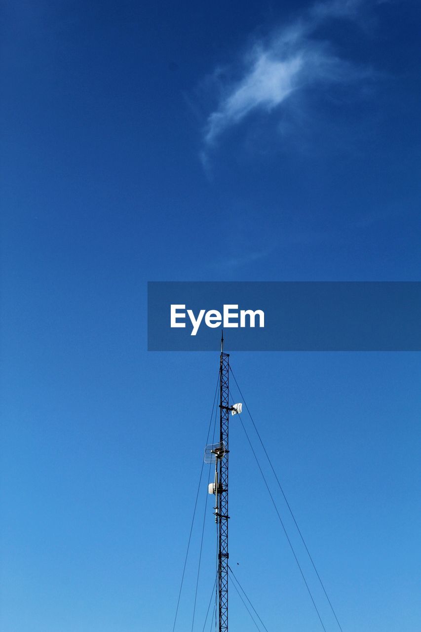 LOW ANGLE VIEW OF POWER LINES AGAINST BLUE SKY