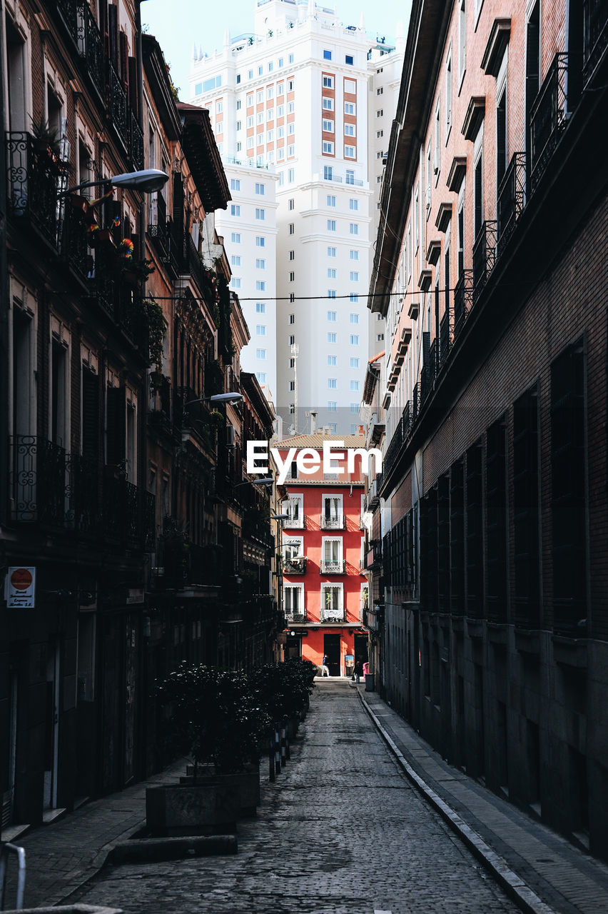 Narrow alley amidst buildings in city