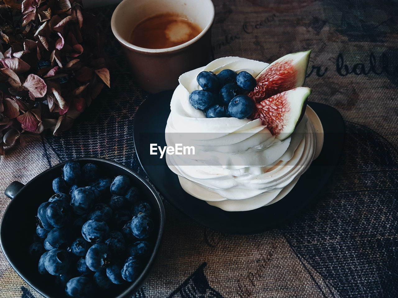 High angle view of pavlova and blueberries on table