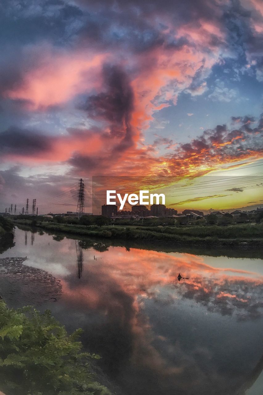 SCENIC VIEW OF FACTORY AGAINST SKY AT SUNSET