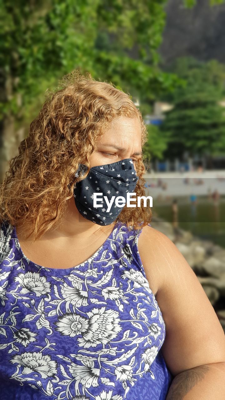 Woman wearing mask standing outdoors