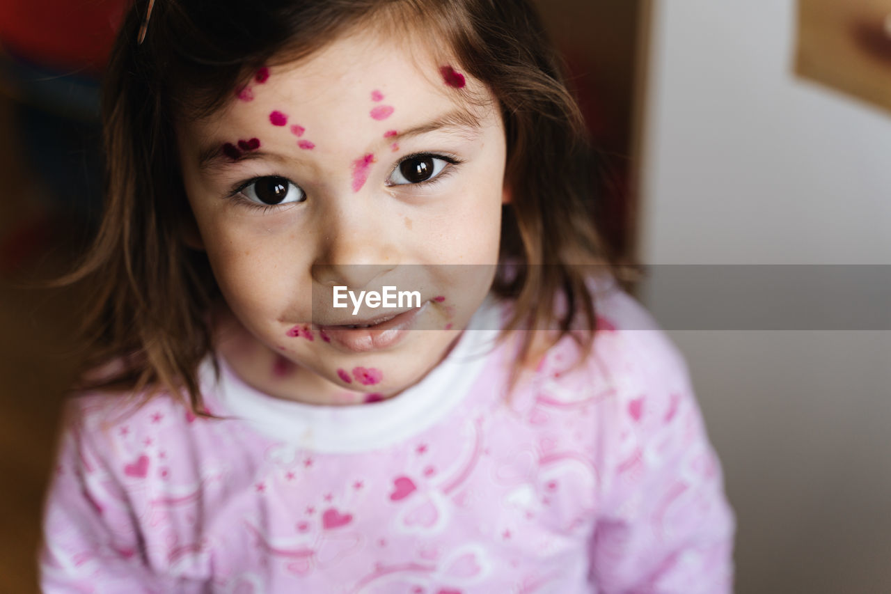 Close-up portrait of cute girl at home