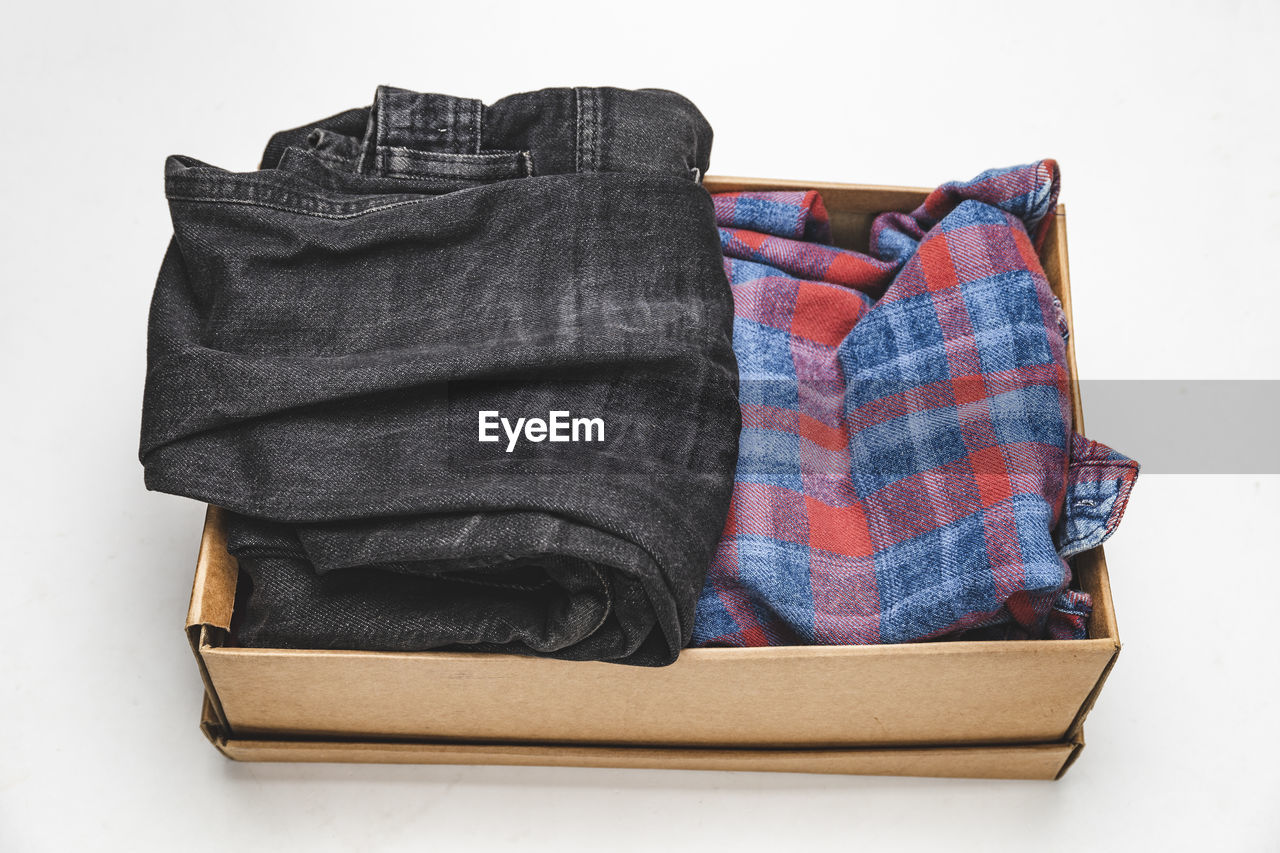 High angle view of clothes in box over white background