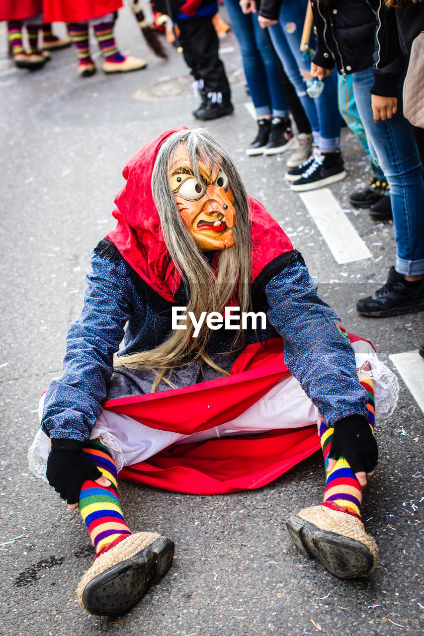 High angle view of person wearing witch costume while sitting on street