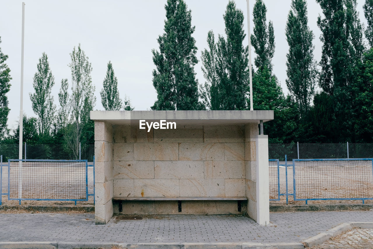 View of empty bus stop against trees