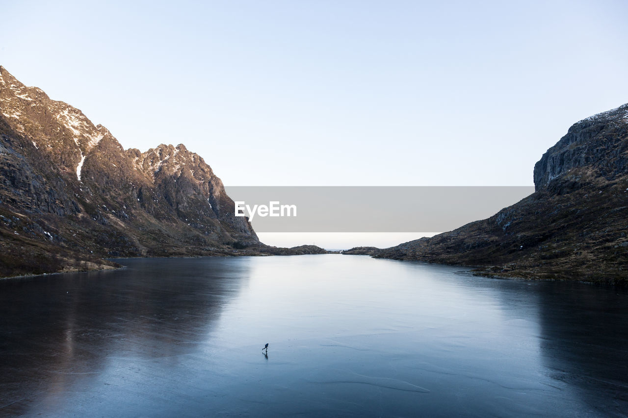 Man paddleboarding on lake