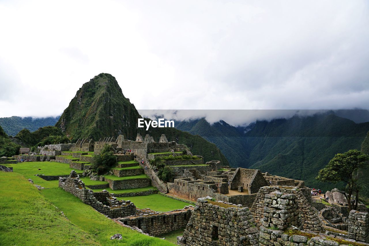 HIGH ANGLE VIEW OF OLD RUINS ON MOUNTAIN AGAINST SKY