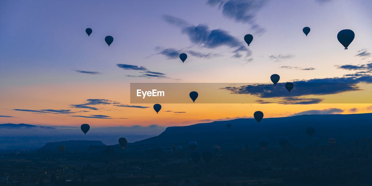 Hot air balloons fly at sunrise over the city of goreme in turkey.
