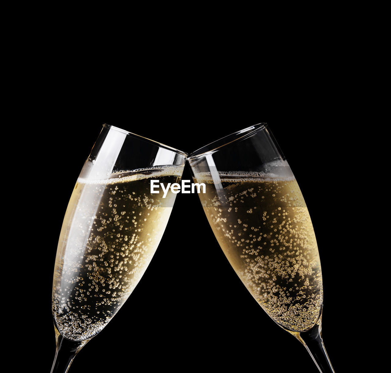 Close-up of champagne flutes against black background