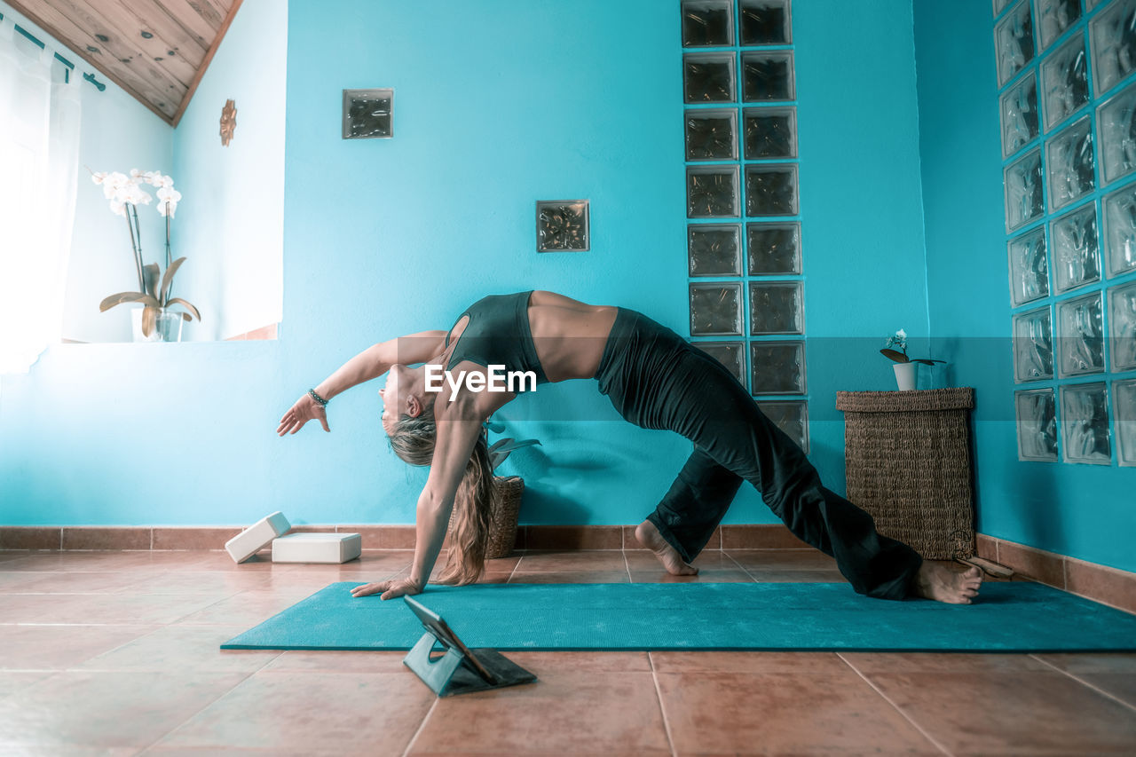 SENIOR MAN SITTING ON FLOOR