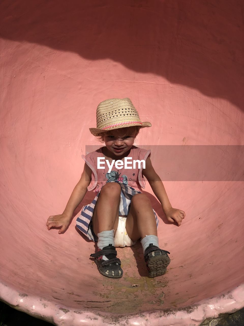 low section of woman sitting on sand at home