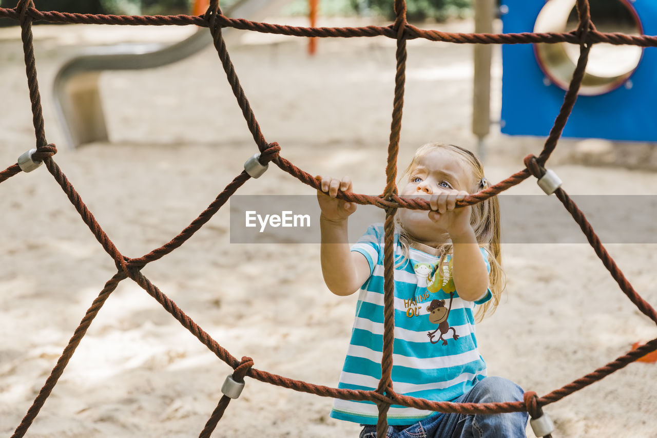 Girl holding rope in playground