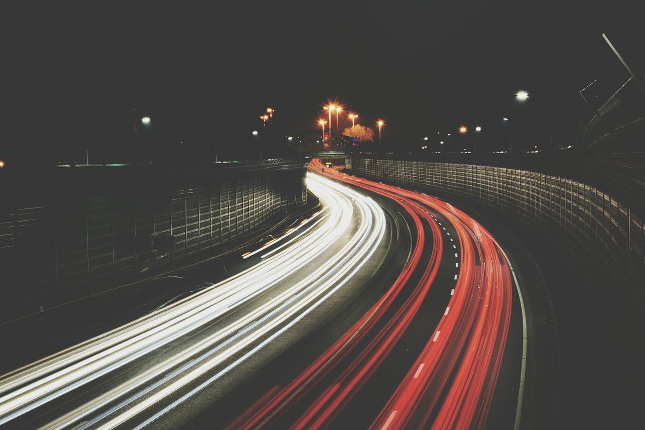 High angle view of light trails on road at night