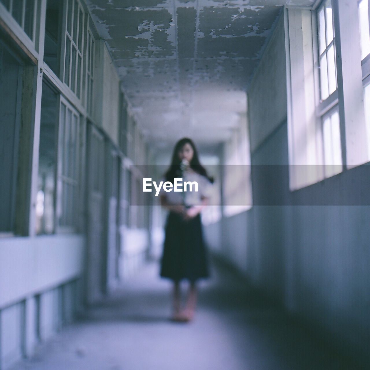 Woman standing in corridor of building