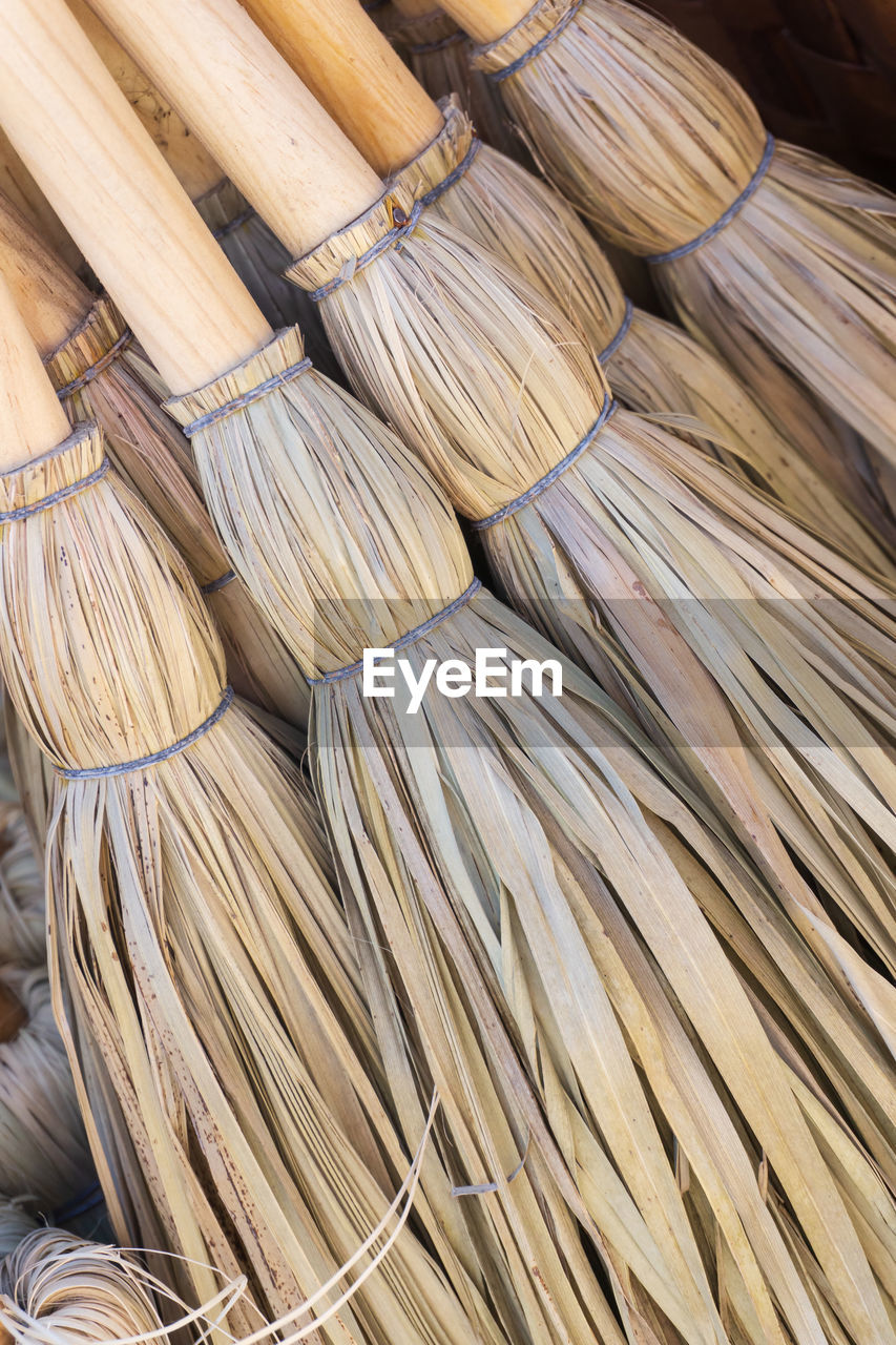 Small eco-friendly handmade brooms close up background