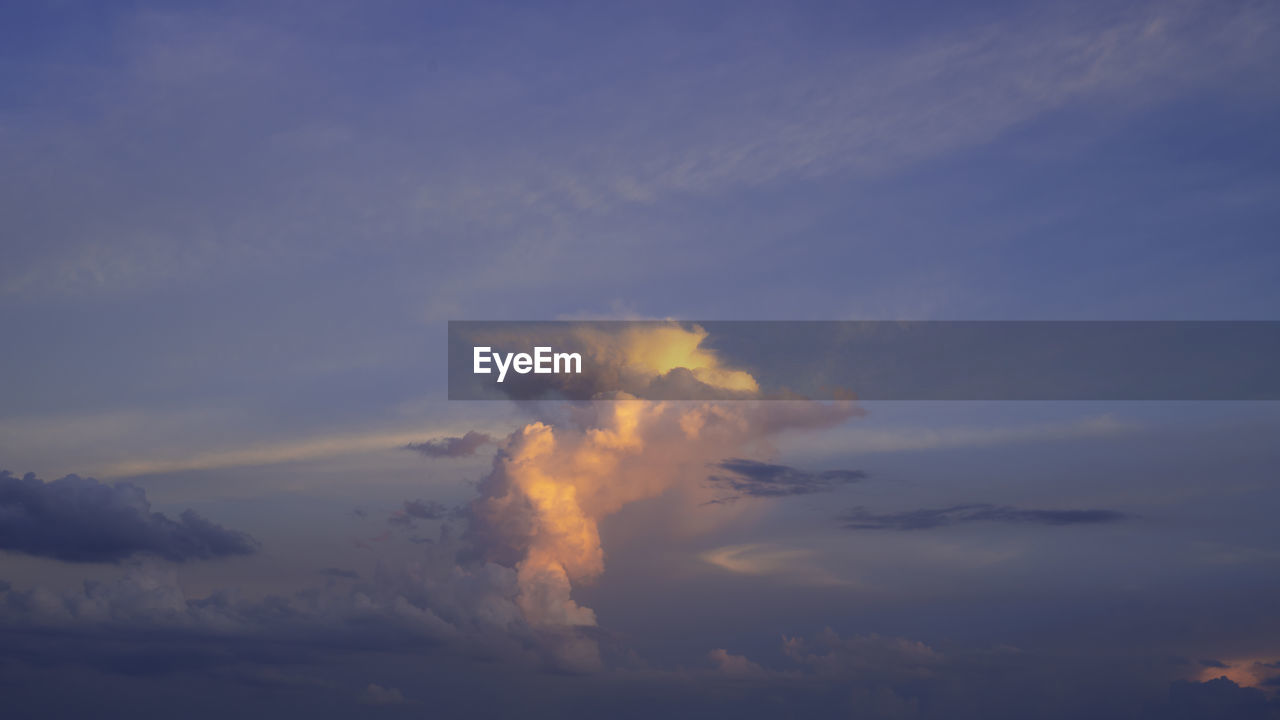 LOW ANGLE VIEW OF SMOKE EMITTING FROM CLOUDS AT SUNSET