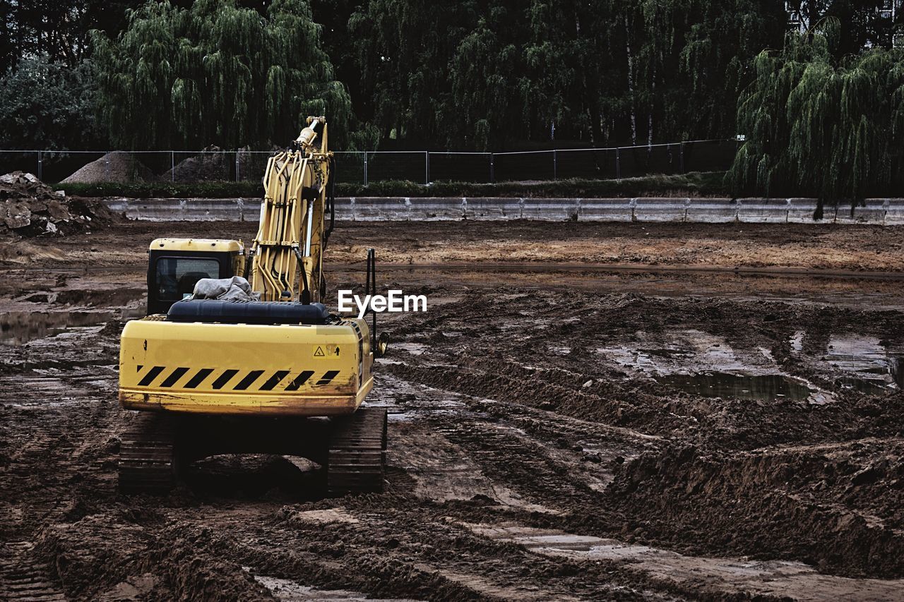 View of excavator against trees