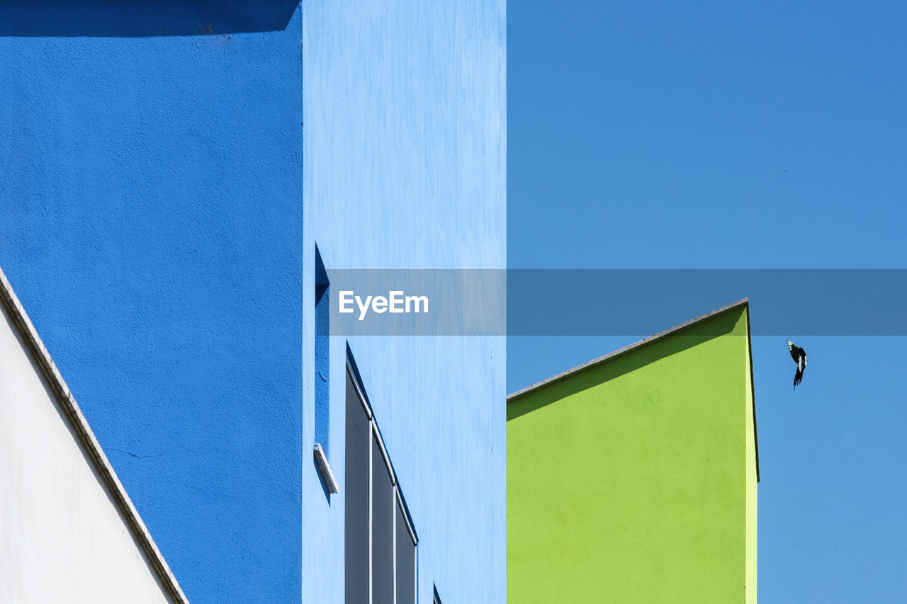 Low angle view of building against clear blue sky