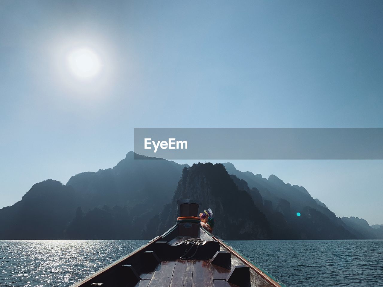 Scenic view of sea and mountains against clear sky