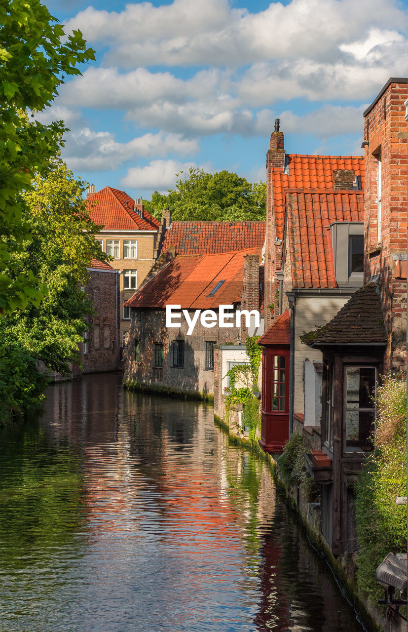 CANAL AMIDST BUILDINGS IN CITY