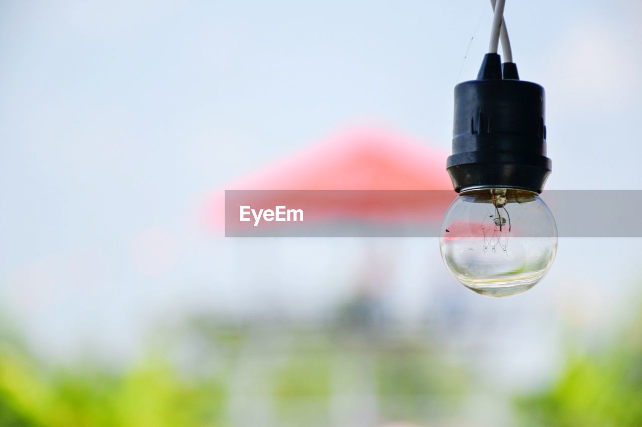 LOW ANGLE VIEW OF LIGHT BULBS AGAINST SKY