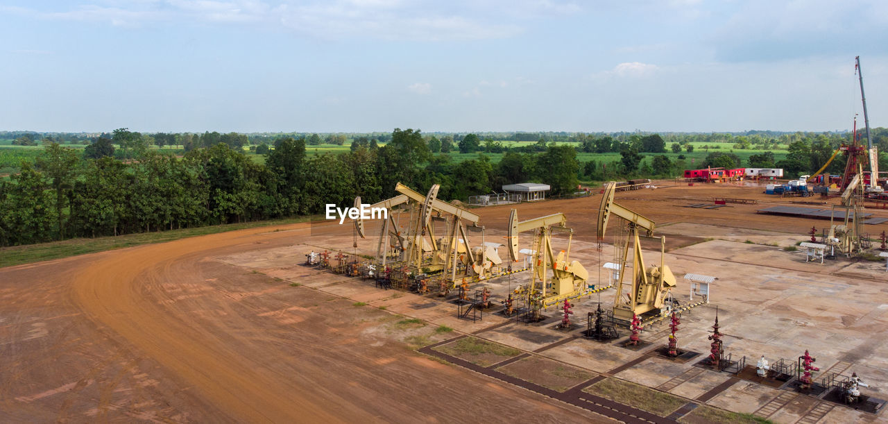 Aerial view of field oil pump jack oil rig machine for pumping natural fossil fuel.