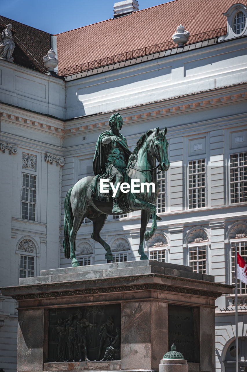 Low angle view of statue against building